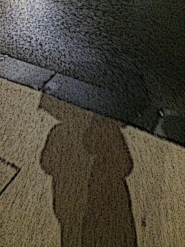 Mr nobody methaphorically picturing his shadow, which is projected on the road. There is the shadow of an umbrella he's wearing too.